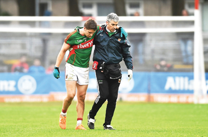 Lee Keegan, Mayo, is assisted off the pitch by Dr Sean Moffatt after picking up an injury.
