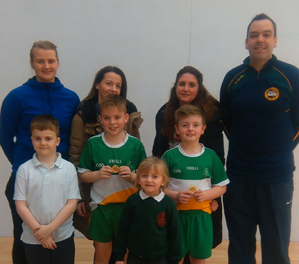 World Champion Aisling Reilly and fellow St Paul's Handball coach Seamus O'Tuama and parents of Bunscoil Phobal Feirste pupils and u/11 Antrim Allianz Cumann na mBunscol Doubles champions Ryan McCoy and Padraig O'Donnell.