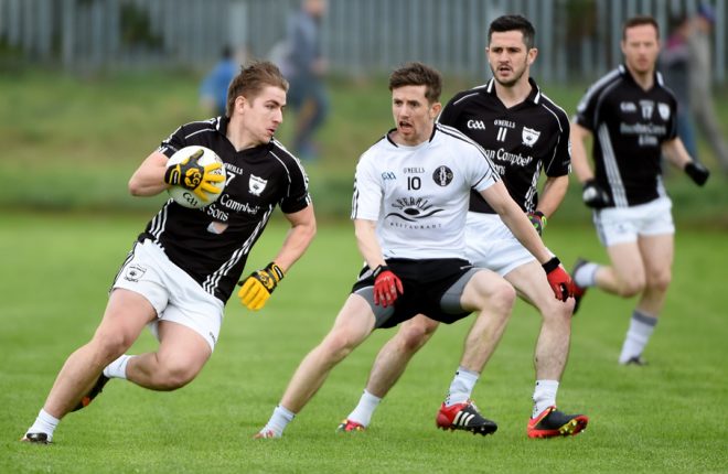 Omagh's Cormac O'Neill attempts to put the stoppers on Clonoe's Dwayne Quinn. MC 37