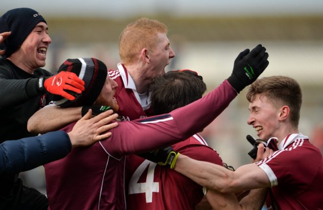Slaughtneil players and fans celebrate at the final whistle